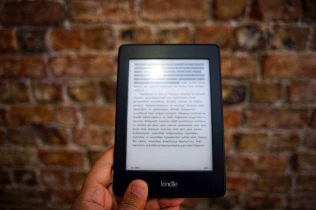 person holding amazon kindle ebook | 7 Simple strategies to increase your amazon book sales online